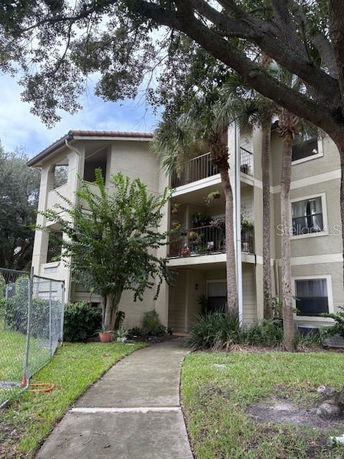 Front view of a multi-story apartment building with balconies.