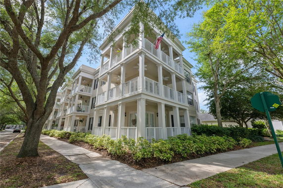 Front view of a three-story building with multiple balconies.