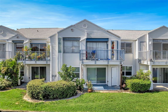 Front view of a multi-story residential building with balconies.