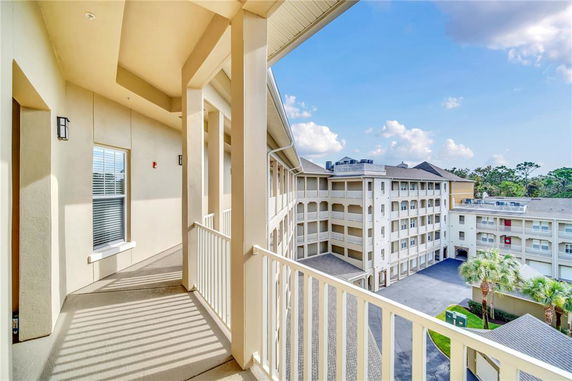 View from a balcony overlooking a multi-story building complex.
