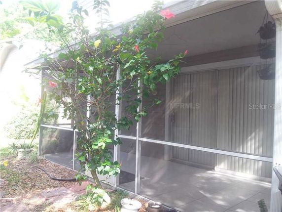 Front view of a screened porch attached to a house.