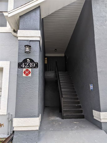 Front view of a multi-story building with an entrance staircase.