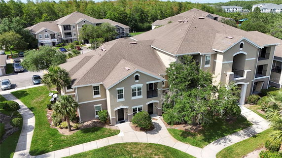 Front view of a multi-story residential building with multiple units and balconies.