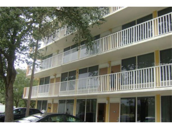 Front view of a multi-story building with balconies.