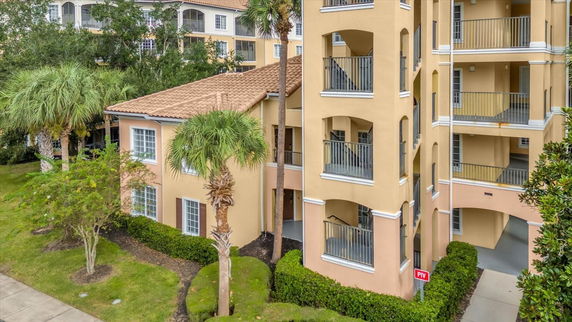 Front view of a multi-story apartment building with balconies.
