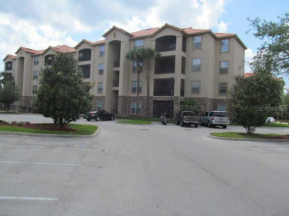 Front view of a multi-story apartment building with multiple balconies.