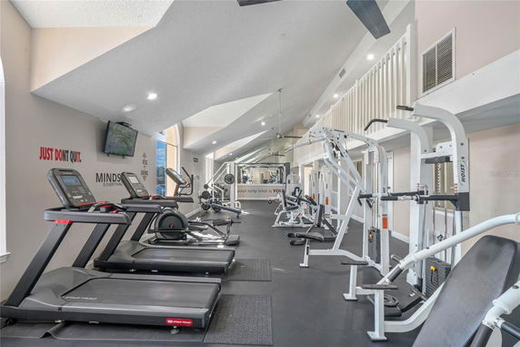 Indoor gym area with exercise machines and treadmills.