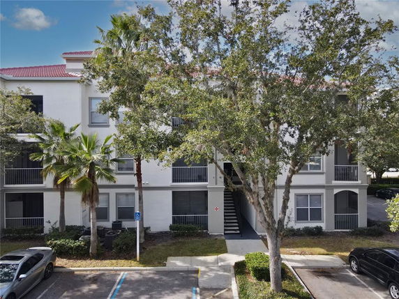 Front view of a multi-story residential building with balconies.