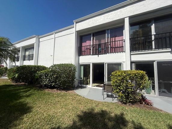 Front view of a two-story building with large windows and balconies.