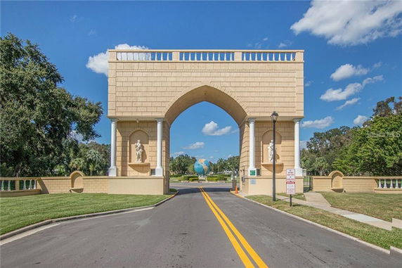 Front view of a large archway entrance structure with statues and pillars.