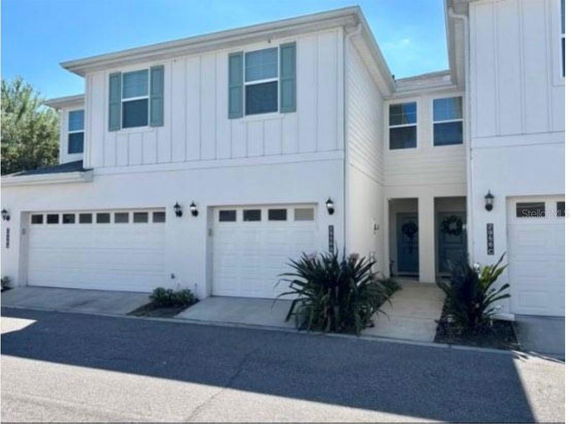 Front view of a two-story house with double garage doors.