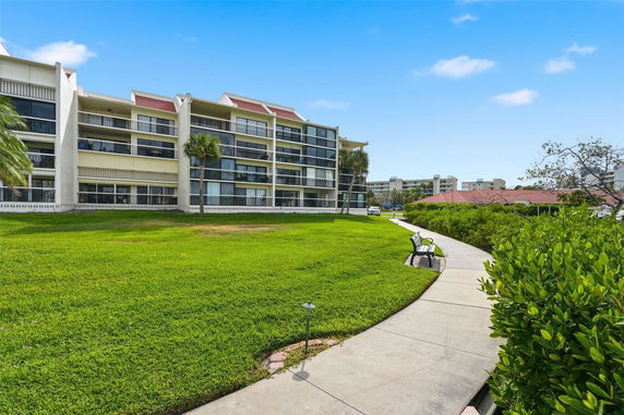 Front view of a multi-story residential building with balconies.