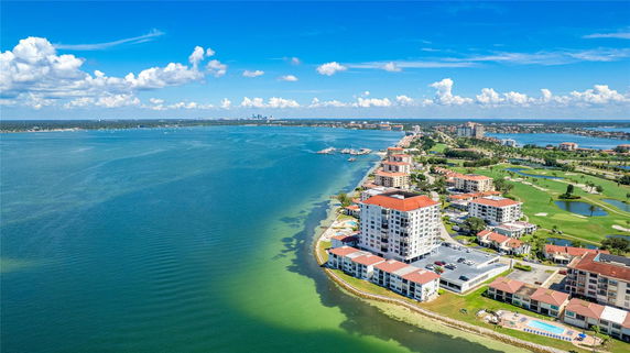 Wide angle view of coastal residential area with buildings along the shoreline.