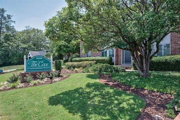 Front view of a condominium building with a sign indicating 'The Cove'.