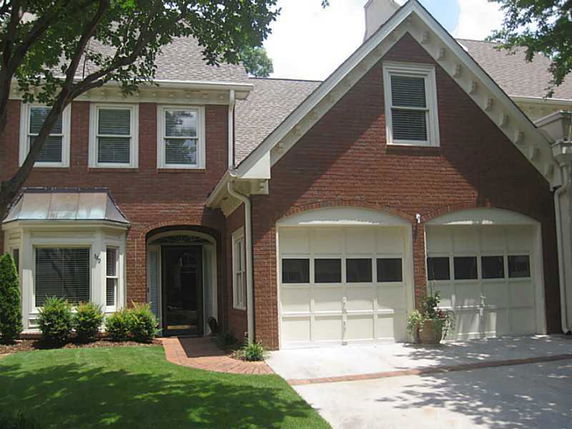 Front view of a two-story brick house with a double garage.