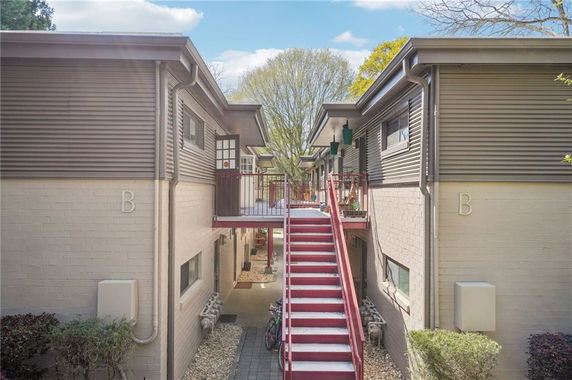 Front view of a two-story apartment building with central staircase.
