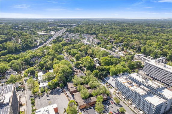 Panoramic view of a cityscape with buildings and greenery.