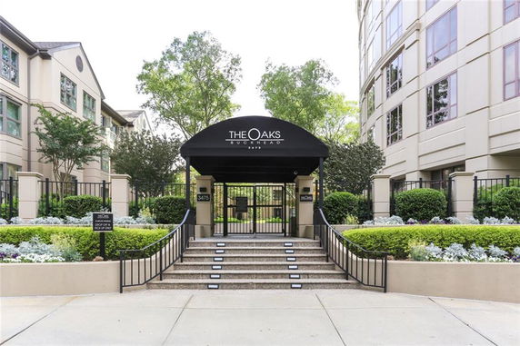 Front view of the entrance to a residential building complex with a covered awning.