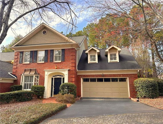 Front view of a two-story brick house with a double garage.
