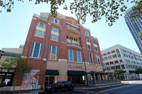 Front view of a multi-story commercial building with large windows.