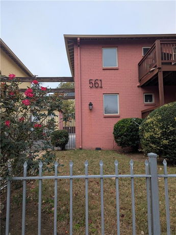 Front view of a two-story building with a balcony.