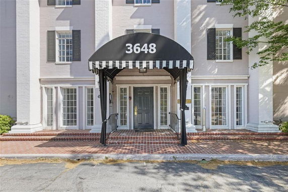 Front view of a building with a black awning and the number 3648 above the entrance.