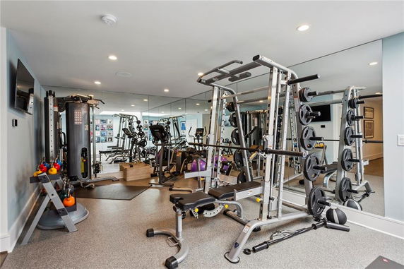 Indoor gym area with exercise equipment and mirrored wall