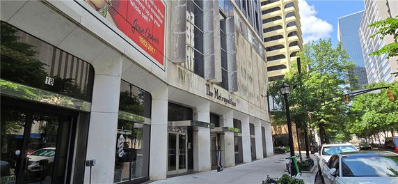 Front view of a multi-story building with a modern facade in an urban setting.