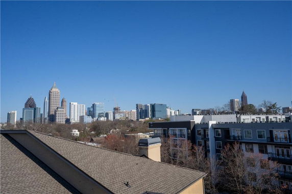Panoramic view of a city skyline with multiple high-rise buildings seen from a rooftop.
