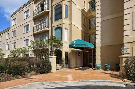 Front view of a multi-story building with an entrance canopy.