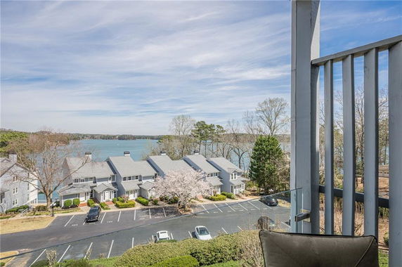 Panoramic view of houses with a lake in the background seen from the building.