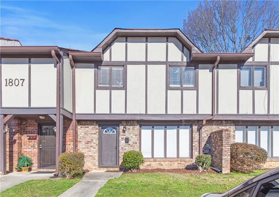 Front view of a two-story townhouse with Tudor-style architecture.