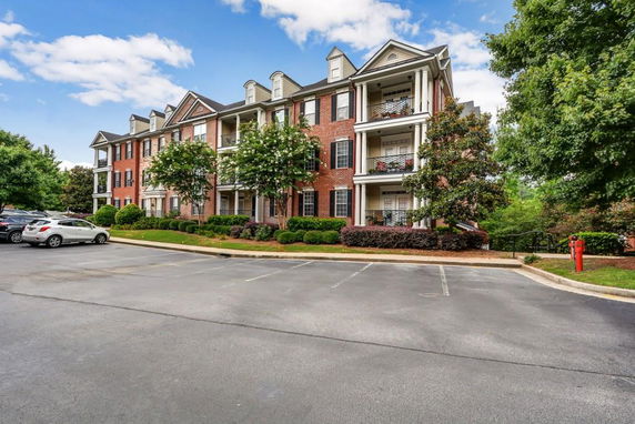Front view of a multi-story brick building with balconies.