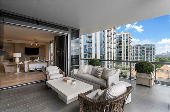 Balcony view overlooking tall modern apartment buildings.