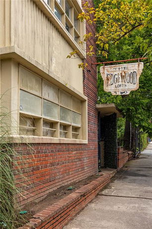 Side view of a brick building with a loft sign.