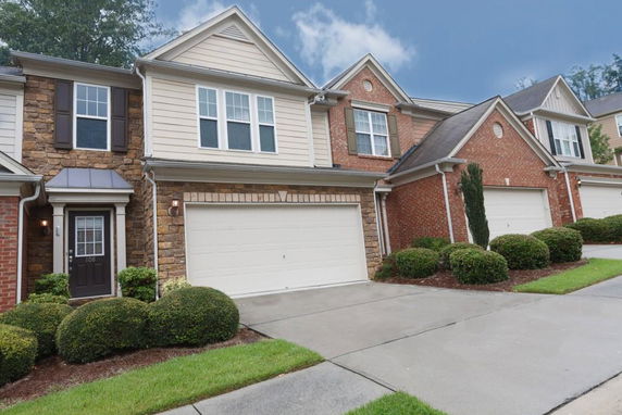 Front view of a two-story townhouse with a garage.