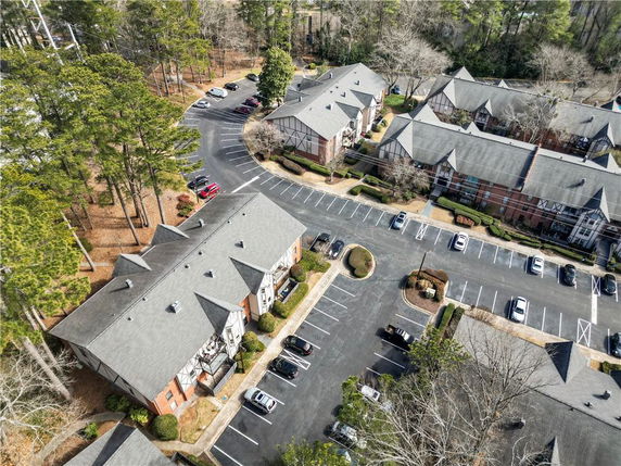 Aerial view of multiple residential buildings with surrounding parking area.