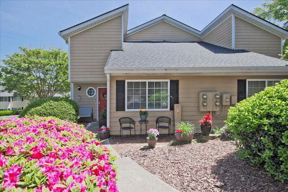 Front view of a house with a sloped roof and porch area.