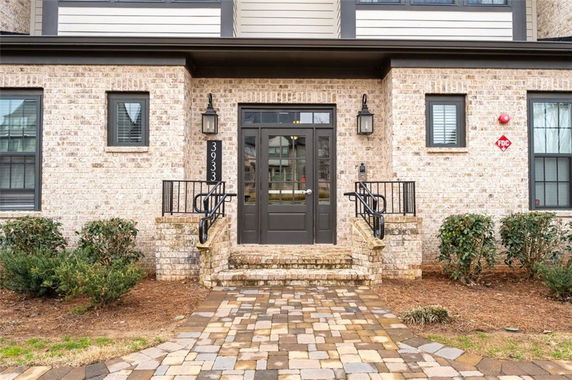 Front view of a brick building entrance with steps.