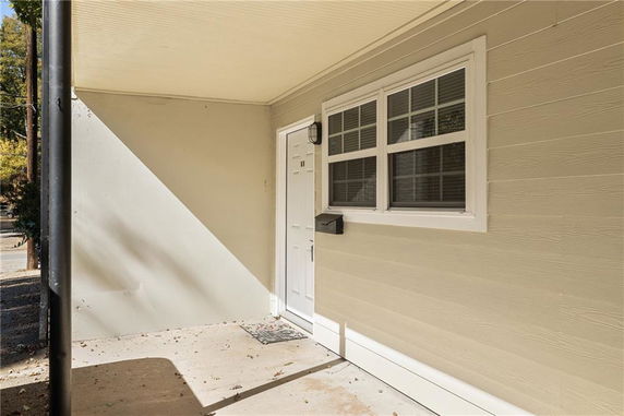 Front view of a house entrance with a door and window.