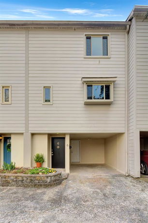 Front view of a multi-story townhouse with a garage.