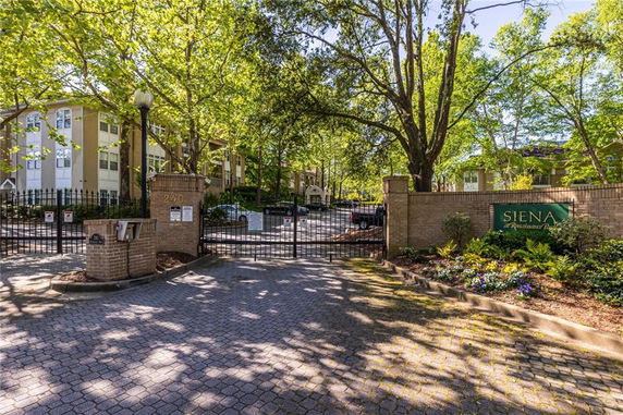 Front view of an apartment complex with a gated entrance.