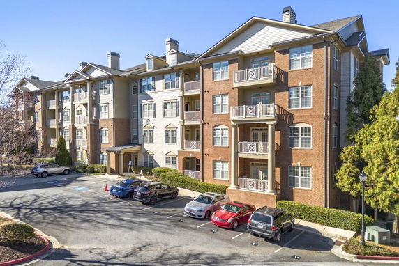Front view of a multi-story apartment building with balconies.