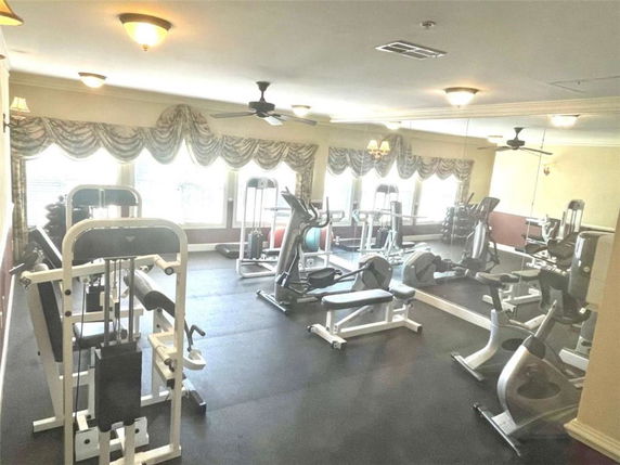 Room with various gym equipment including exercise machines and weights.