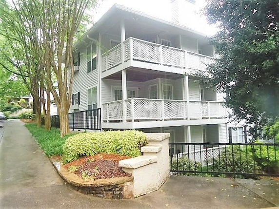Front view of a multi-story house with wraparound balconies.