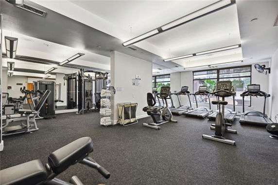 Interior view of a gym area with exercise equipment like treadmills and elliptical machines.