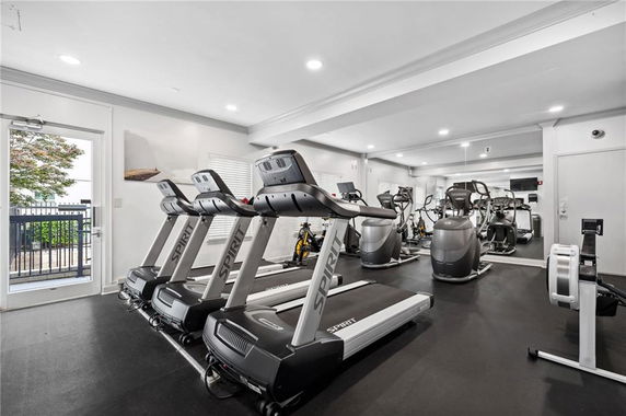 Interior view of a gym with treadmills and exercise machines.