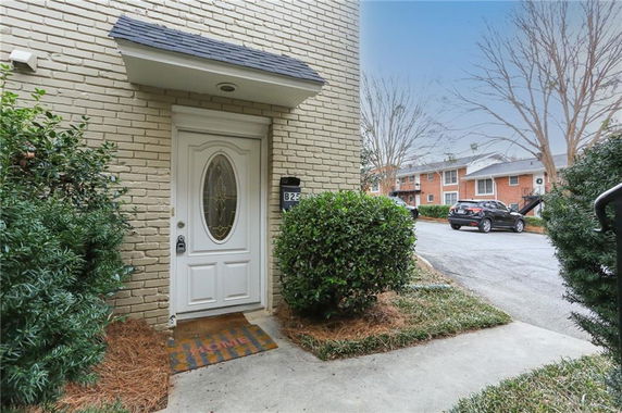 Front view of a residential building entrance with a white door.