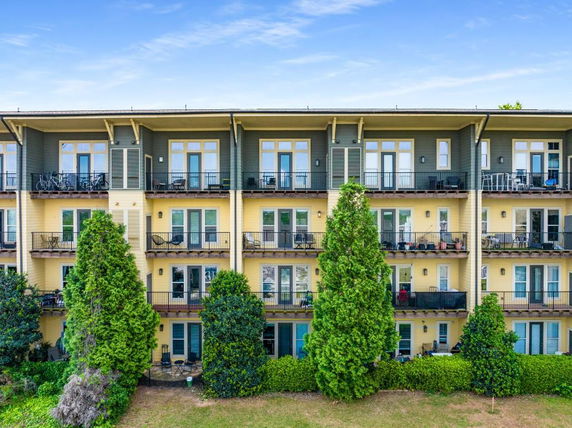 Front view of a multi-story apartment building with balconies.