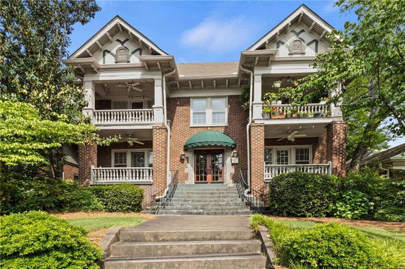 Front view of a two-story brick house with two balconies